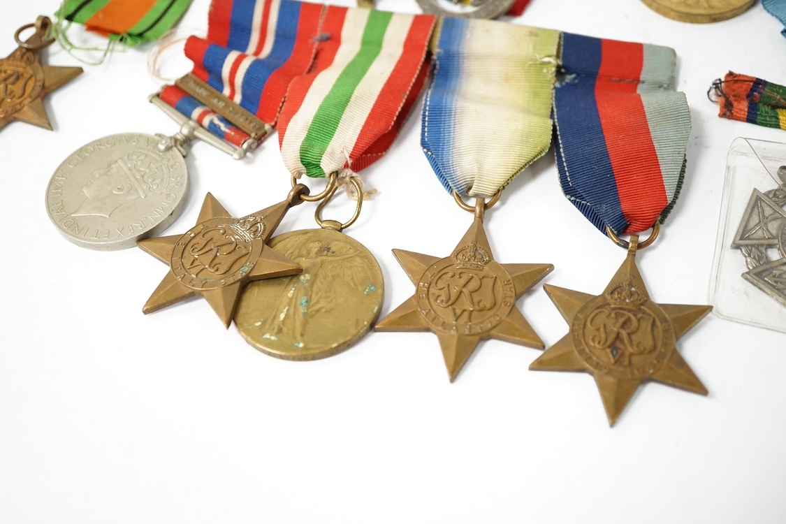 Nine military medals including; a First World War medal pair to T3-026887 DVR. C. Oldfield. A.S.C., a WWII group comprising; The Atlantic Star, The 1939-1945 Star, The Italy Star and The 1939-1945 Medal with a clasp for
